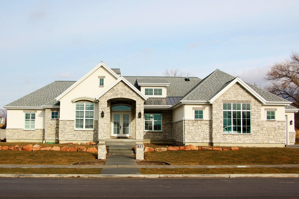 American Fork Classic — stone and stucco custom home with arched entry and steep gabled rooflines