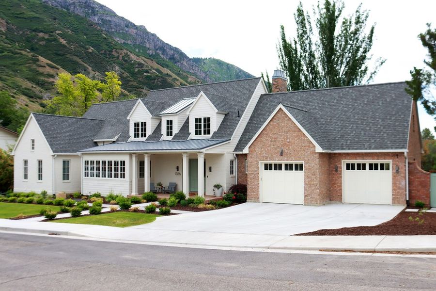 Provo Classic custom home by Haven Homes in Provo, Utah, white farmhouse with a brick garage and mountain views